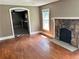 Living room with hardwood floors, stone fireplace and kitchen view at 2203 Hillcrest Ave, Decatur, GA 30032