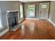 Living room with hardwood floors, stone fireplace and view to kitchen at 2203 Hillcrest Ave, Decatur, GA 30032