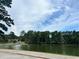 Serene lake view with lush green trees and blue skies at 2203 Hillcrest Ave, Decatur, GA 30032