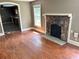 Living room with hardwood floors, stone fireplace and kitchen view at 2203 Hillcrest Ave, Decatur, GA 30032