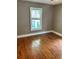 Spacious bedroom featuring hardwood floors and a large window at 2203 Hillcrest Ave, Decatur, GA 30032