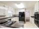 Modern kitchen boasts black appliances and granite countertops at 2466 Country Club Dr, Conyers, GA 30013