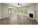 Living room with hardwood floors, fireplace, and ceiling fan at 320 Pintail Ct, Suwanee, GA 30024