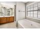 Bathroom with double vanity, soaking tub, and separate shower at 320 Pintail Ct, Suwanee, GA 30024