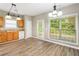 Kitchen features wood cabinets and a view to the backyard at 320 Pintail Ct, Suwanee, GA 30024