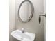 Small bathroom with pedestal sink, oval mirror, and dark ring at 320 Pintail Ct, Suwanee, GA 30024