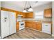 Kitchen with white appliances and wood cabinets at 320 Pintail Ct, Suwanee, GA 30024