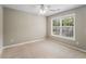 Bright bedroom featuring a large window and ceiling fan at 320 Pintail Ct, Suwanee, GA 30024