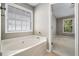 Bathroom with garden tub and access to bedroom at 320 Pintail Ct, Suwanee, GA 30024