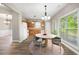 Eat-in kitchen with wood cabinets, round table, and view to backyard at 320 Pintail Ct, Suwanee, GA 30024