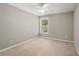 Well-lit bedroom with neutral walls and carpet at 320 Pintail Ct, Suwanee, GA 30024