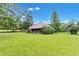 Red house with front porch and large yard at 200 Ross St, Carrollton, GA 30116