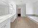 Spacious bathroom with double vanity, large soaking tub, and separate shower at 2669 Saint Paul Sw Dr, Atlanta, GA 30331