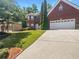 Brick house with a two car garage and manicured lawn at 2669 Saint Paul Sw Dr, Atlanta, GA 30331
