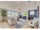 Spacious living room featuring a fireplace, large windows, and comfortable seating at 21 Bennett Farm Dr, Loganville, GA 30052