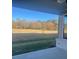 Covered patio overlooking a spacious backyard with mature trees and open field at 2404 Anhinga Dr, Loganville, GA 30052