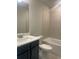 Updated bathroom with a single vanity, toilet, and bathtub at 2404 Anhinga Dr, Loganville, GA 30052