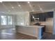 Modern kitchen featuring a large island, stainless steel appliances, and hardwood floors at 2404 Anhinga Dr, Loganville, GA 30052
