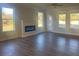 Spacious living room with hardwood floors, fireplace, and plenty of natural light at 2404 Anhinga Dr, Loganville, GA 30052