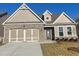 Brick and shingle two-story home with three-car garage and landscaped yard at 2414 Anhinga Dr, Loganville, GA 30052