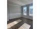 Bright living room with hardwood floors and large windows at 2414 Anhinga Dr, Loganville, GA 30052