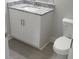 Small bathroom with granite countertop, white vanity, and toilet at 559 Fundao Ln # 21, Lawrenceville, GA 30046