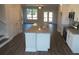 Kitchen with island, granite countertops, and stainless steel appliances at 559 Fundao Ln # 21, Lawrenceville, GA 30046