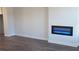 Living room with modern electric fireplace and vinyl plank flooring at 559 Fundao Ln # 21, Lawrenceville, GA 30046