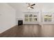 Bright living room featuring hardwood floors, fireplace, and large windows at 1641 Lacebark Elm Way, Lawrenceville, GA 30045