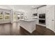 Modern kitchen boasting white cabinets, island, and stainless steel appliances at 1641 Lacebark Elm Way, Lawrenceville, GA 30045