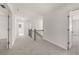 Upstairs hallway with carpet and doors to bedrooms at 1641 Lacebark Elm Way, Lawrenceville, GA 30045