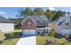 Brick two-story house with a two-car garage and landscaped yard at 1641 Lacebark Elm Way, Lawrenceville, GA 30045