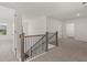 Upstairs hallway with staircase and doors to bedrooms at 1641 Lacebark Elm Way, Lawrenceville, GA 30045