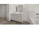 Bathroom with double vanity, tile floor, and soaking tub at 1641 Lacebark Elm Way, Lawrenceville, GA 30045