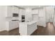 Modern kitchen with white cabinets, large island, and stainless steel appliances at 1641 Lacebark Elm Way, Lawrenceville, GA 30045