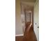 Long hallway with hardwood floors and multiple doors leading to other rooms at 2955 Seven Pines Ln # 206, Atlanta, GA 30339
