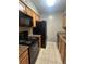 Galley kitchen with granite countertops and black appliances at 2955 Seven Pines Ln # 206, Atlanta, GA 30339