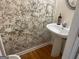 Small powder room with pedestal sink and patterned wall at 4870 Hairston Park Sq, Stone Mountain, GA 30083
