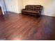 Living room with dark hardwood floors and a brown couch at 4870 Hairston Park Sq, Stone Mountain, GA 30083