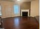 Living room with hardwood floors and a corner fireplace at 4870 Hairston Park Sq, Stone Mountain, GA 30083