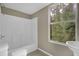 Clean bathroom with shower/tub combo and window at 8446 Donald Rd, Snellville, GA 30039