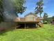 Elevated deck with built-in hot tub, stairs, and grassy yard at 2653 Tilson Rd, Decatur, GA 30032