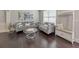 Living room with hardwood floors, gray sofas, and a white bench at 437 Livingston Pt, Acworth, GA 30102