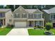 Two-story house with light brown siding and landscaping at 437 Livingston Pt, Acworth, GA 30102