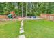 Spacious backyard with playground, fire pit, and seating at 437 Livingston Pt, Acworth, GA 30102
