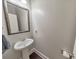 Small bathroom with pedestal sink and framed mirror at 437 Livingston Pt, Acworth, GA 30102