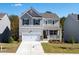 Two-story house with a gray exterior, two-car garage, and landscaping at 675 Highgrove Way, Dallas, GA 30157