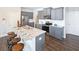 Kitchen boasts an island with seating, granite counters, and gray cabinets at 12000 Conrad Cir, Hampton, GA 30228