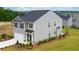 Two-story house with gray siding, black windows, and a two-car garage at 12000 Conrad Cir, Hampton, GA 30228