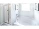 Bathroom featuring a soaking tub and walk-in shower at 12000 Conrad Cir, Hampton, GA 30228